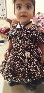 Adorable child in a sparkling dress with a brown tone.