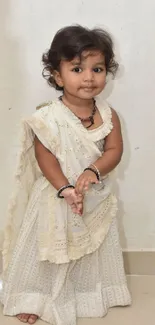 Adorable child wearing traditional attire with an innocent smile.