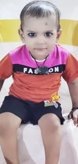 Adorable child sitting on a white chair.