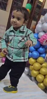 Smiling child surrounded by colorful balloons.