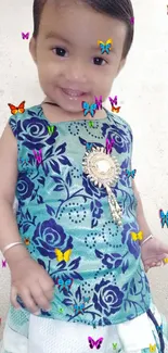 Smiling child in a floral outfit with colorful butterflies.