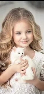 Wallpaper of a charming girl holding a white kitten, exuding innocence and warmth.