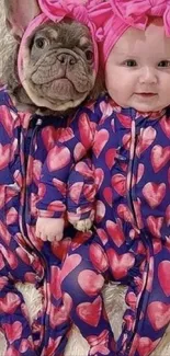 Baby and puppy in matching heart pajamas.