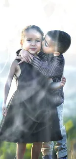 Two young children sharing a warm hug in a picturesque outdoor setting.