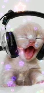 Adorable kitten with headphones and glowing stars wallpaper.