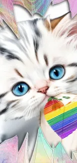 A cute kitten with blue eyes holds a colorful rainbow heart.