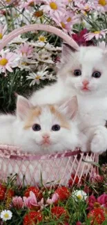 Two fluffy kittens resting in a basket surrounded by flowers.