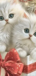 Two fluffy white kittens in a gift box with a red bow.