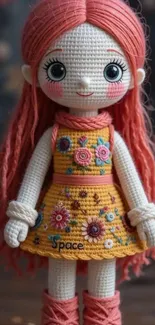 Adorable knit doll with coral pink hair and embroidered dress.