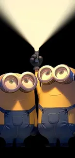 Two Minions under a spotlight, smiling happily.