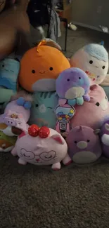 A vibrant collection of plush toys in various pastel colors, perfect for wallpaper.