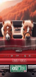 Two cute ponies in a red truck with scenic autumn background.