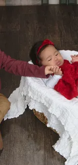 An adorable sibling moment in a cozy setting with red accents.