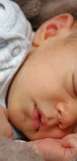 Adorable baby sleeping in warm, soft blanket with a peaceful expression.