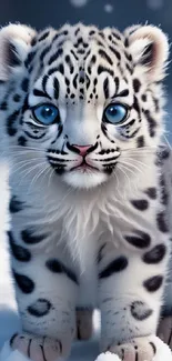 Adorable snow leopard cub with blue eyes in a snowy setting, perfect for mobile screens.