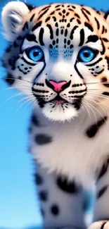 Cute snow leopard cub with blue eyes in a snowy setting.