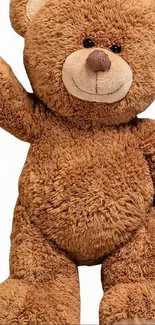 Charming teddy bear with raised paw, brown plush texture.