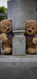 Two teddy bears behind stone pillars on a wallpaper.