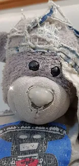 Adorable teddy bear with a patched face.