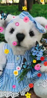 Teddy bear in blue dress with flowers in forest.