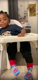 Adorable toddler sitting in a highchair, wearing colorful socks.