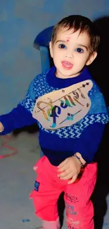 Adorable toddler in navy blue with vibrant pants.