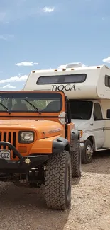 Orange Jeep and camper in desert setting.