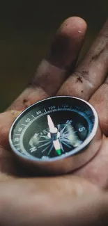 Close-up of a compass held in a hand, emphasizing adventure.