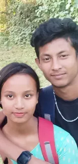 Young couple enjoying a nature hike, surrounded by greenery.