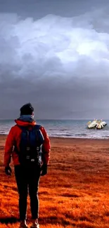 Adventurer by orange shore with dramatic clouds.