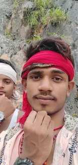 Smiling friends pose for a selfie outdoors against a rocky background.