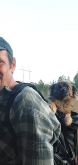 Man hiking with dog companion in outdoor setting.