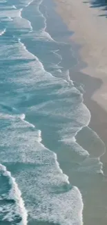 Aerial view of ocean waves along a sandy beach.