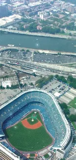 Aerial view of cityscape with a large stadium and greenery.