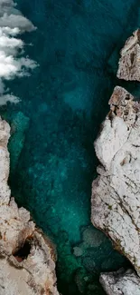 Aerial view of turquoise waters and coastal rocks.