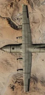 Aerial view of an aircraft flying over a sunlit desert landscape.