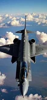 Aerial view of a fighter jet soaring above white clouds against a blue sky.