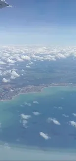 Aerial view of ocean meeting sky with clouds.