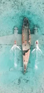 Aerial view of a plane wreck submerged in turquoise ocean waters.