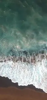 Aerial view of ocean waves crashing on a sandy beach, creating a serene wallpaper effect.