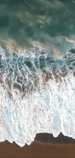 Aerial view of ocean waves crashing on a sandy beach.