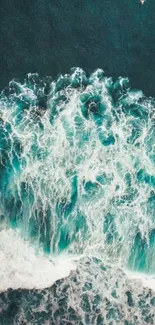 Aerial view of teal ocean waves crashing beautifully.