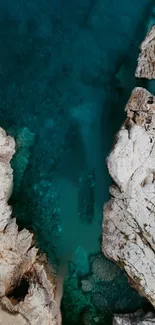 Aerial view of a rocky coastline with turquoise waters and rugged textures.