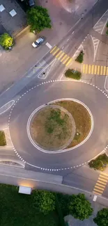 Aerial view of a roundabout at dusk with distinct urban design.