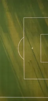 Aerial view of soccer field with shadows and bright green grass.