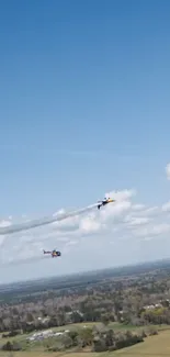 Two stunt planes performing in a clear blue sky.