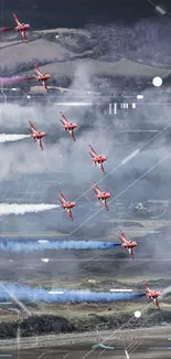 Aerobatic planes perform synchronized aerial display over scenic landscape.