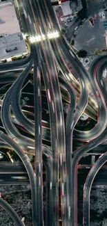 Aerial view of urban highway interchange with intricate road patterns.