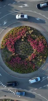 Aerial view of a circular garden roundabout with colorful flowers and green plants.