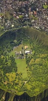 Aerial photo of a lush, green crater beside a bustling cityscape.